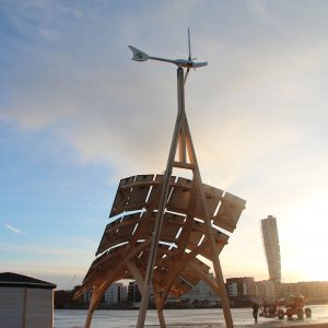 Giraffe 2.0 wind turbine and solar PV on wooden construction with Turning Torso